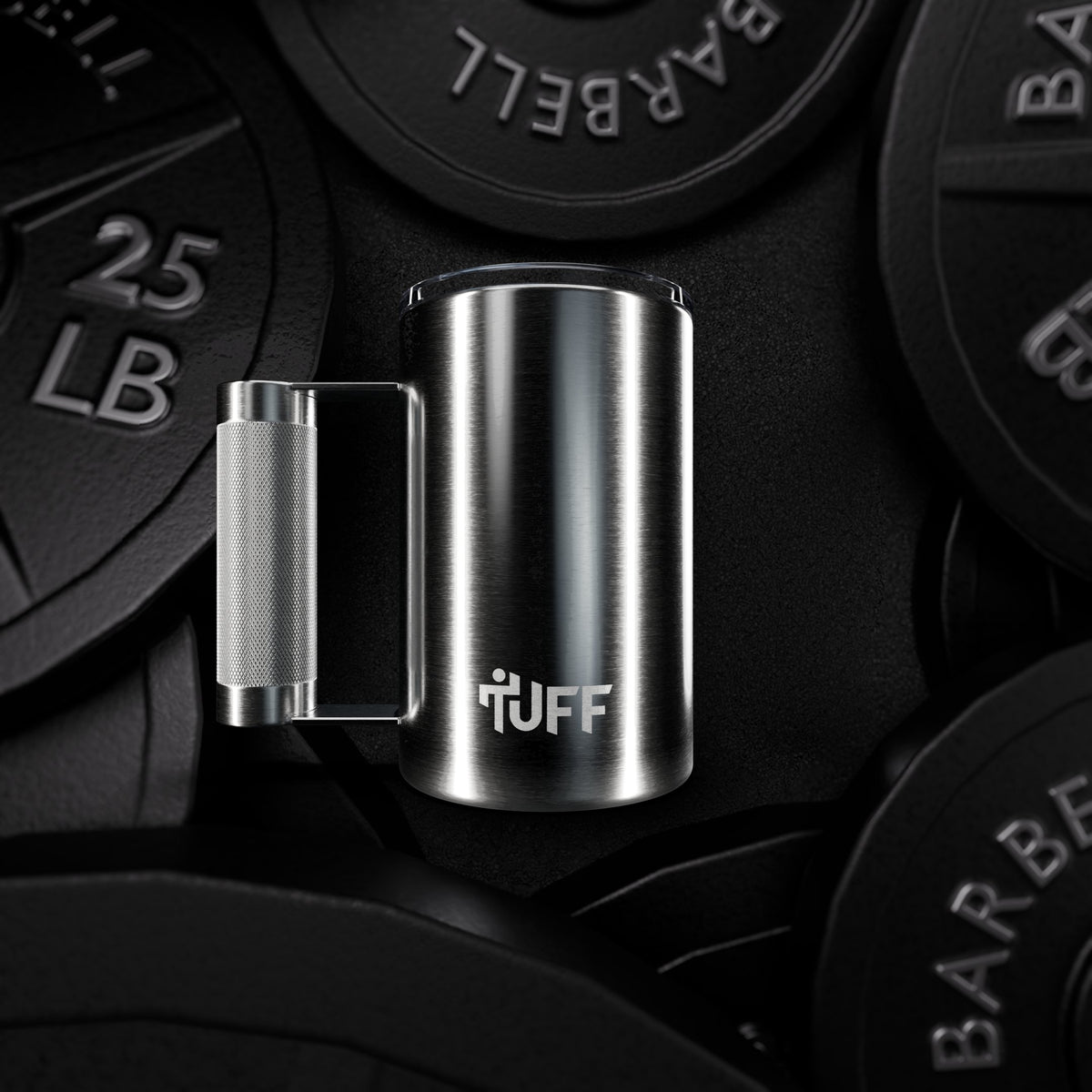 The Tuff Mug standing among barbell plates