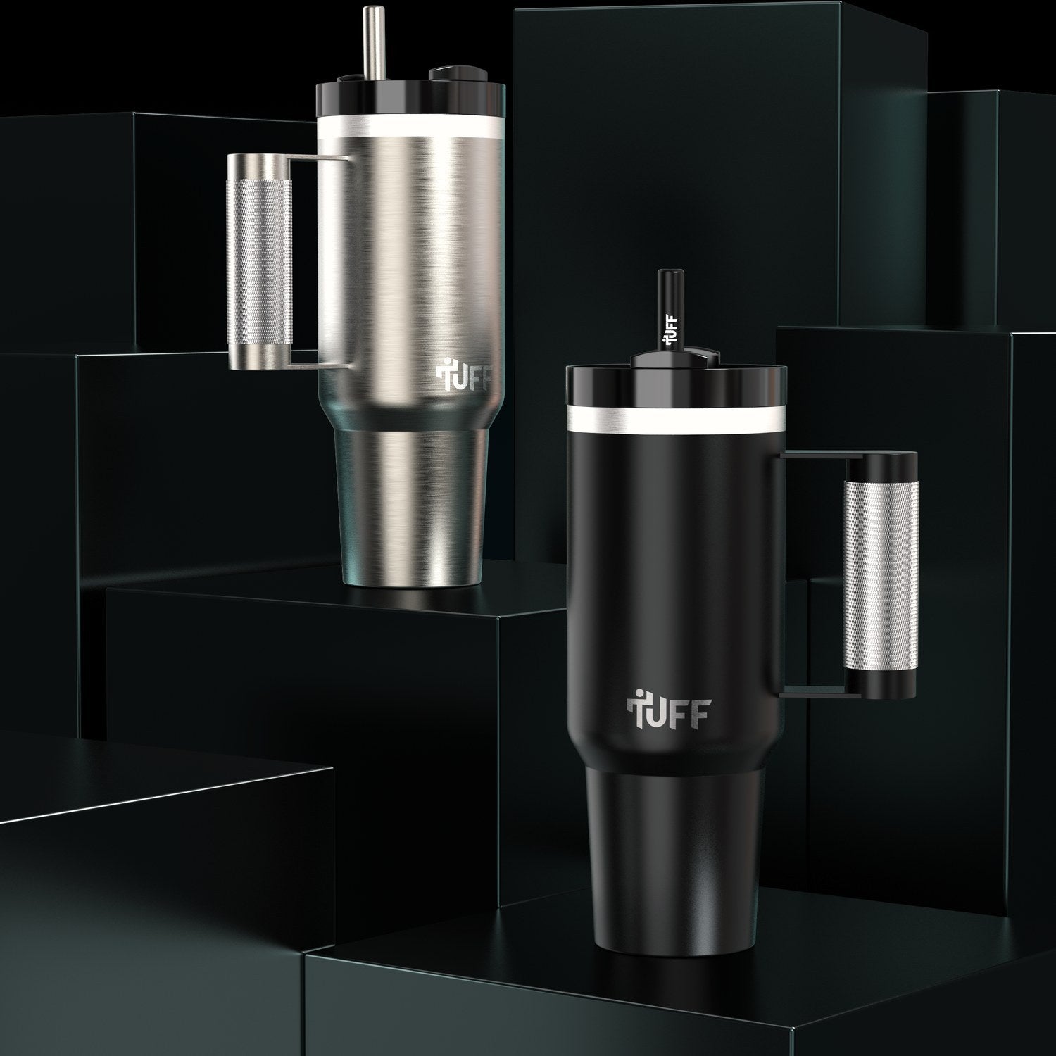 The silver and the black 40 oz Tuff Tumbler side by side on dark blocks.