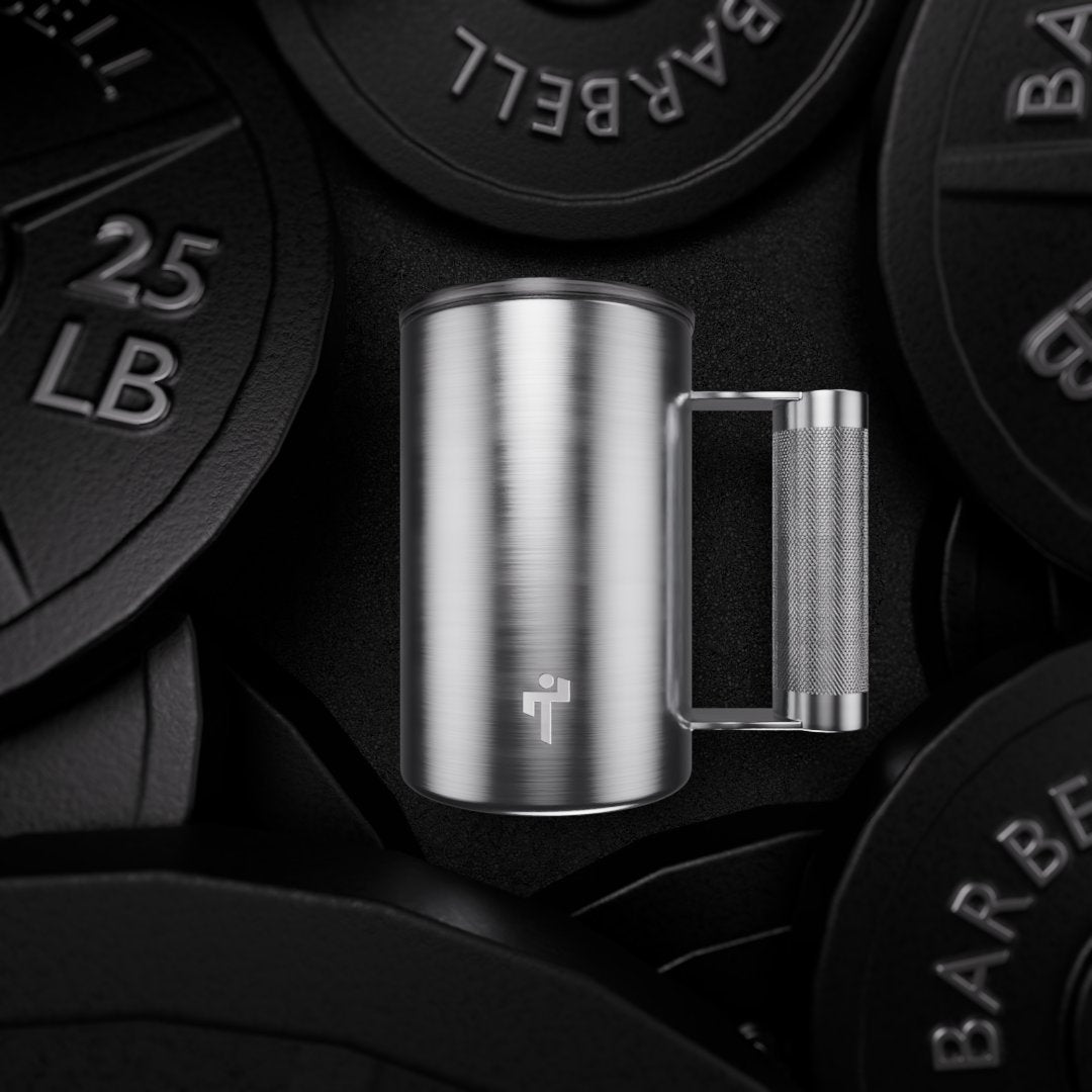 Tuff Mug centered against black barbell plates