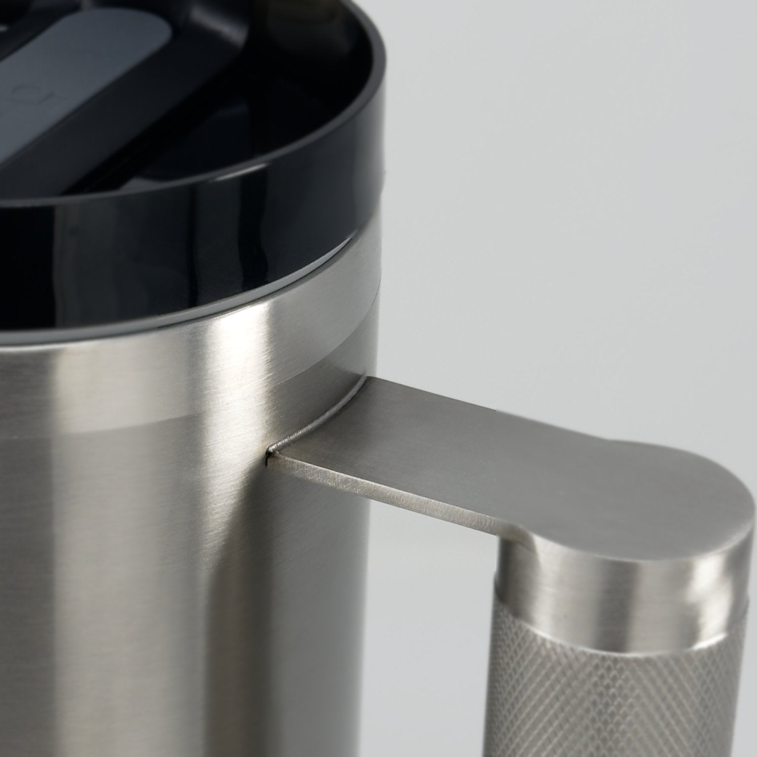 Close-up of the welded joint where the barbell handle meets the stainless body