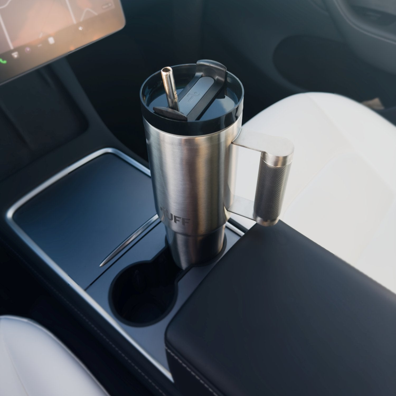 The Tuff Tumbler standing in a car's centre-console cupholder