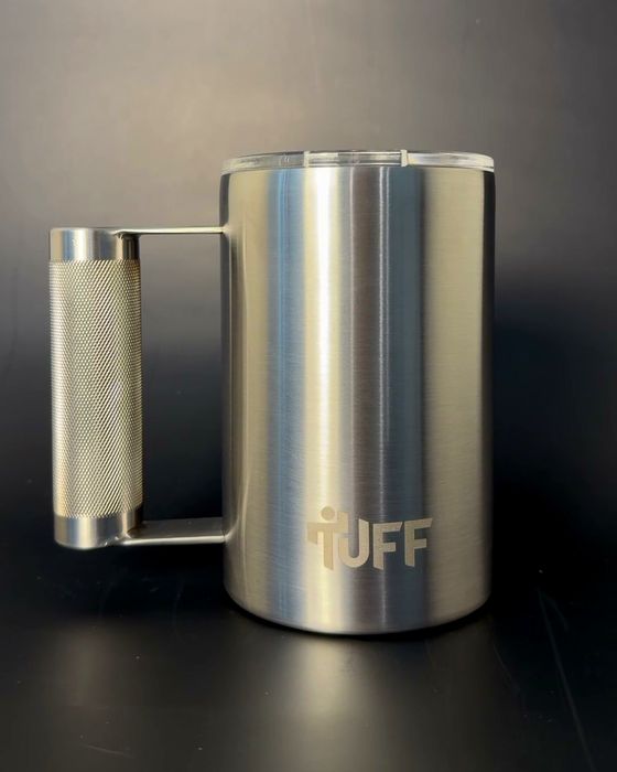 The silver Tuff Mug in three-quarter view on a dark studio ground, whole knurled handle and full TUFF mark visible.