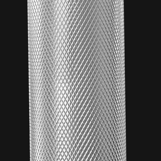 Macro of the diamond knurling cut into the barbell handle.