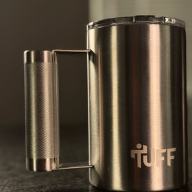 The silver Tuff Mug on the dark kitchen counter.